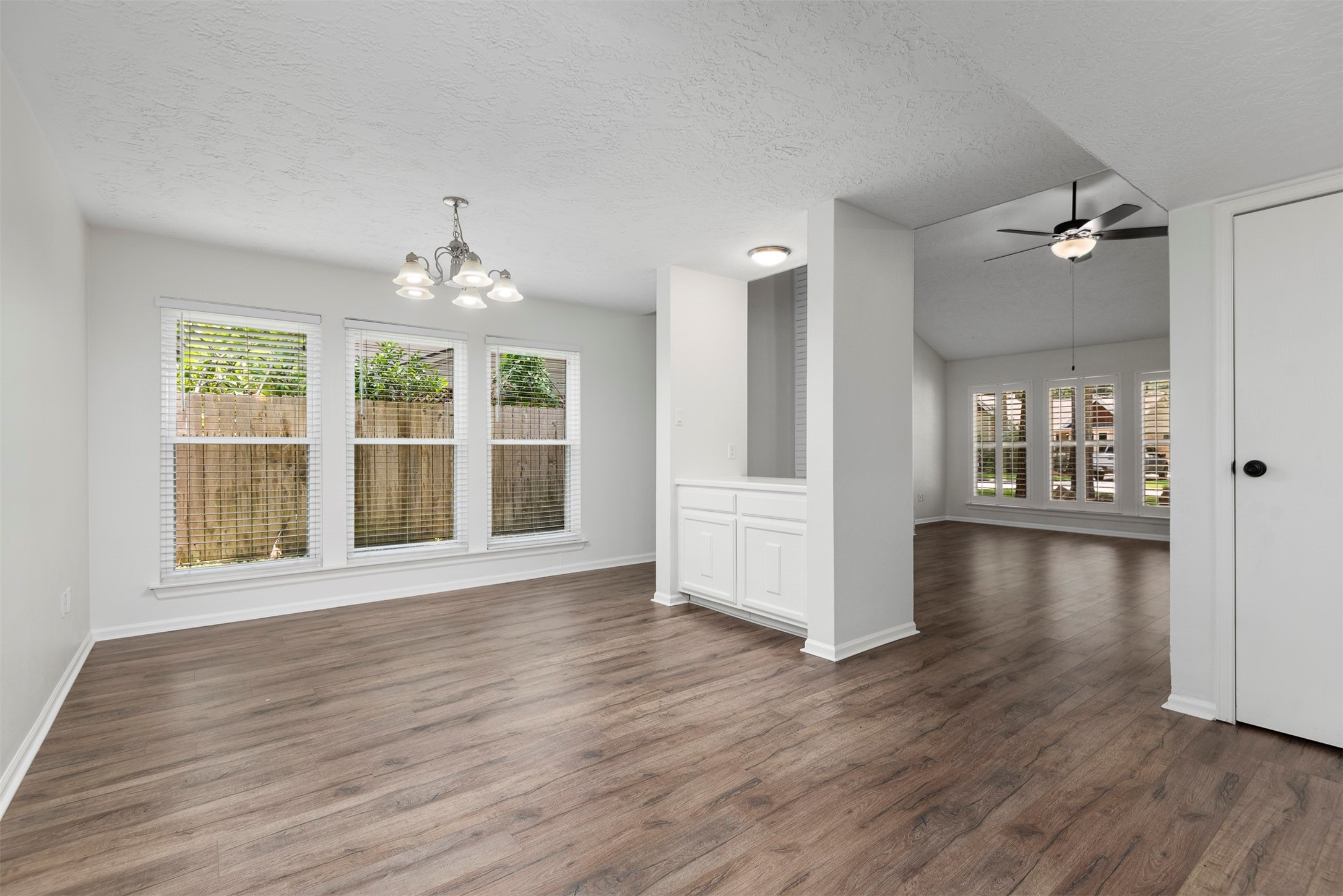 30 Berryfrost Lane The Woodlands, TX 77380 - Photo 16 of 33 a view of an empty room with wooden floor and a window