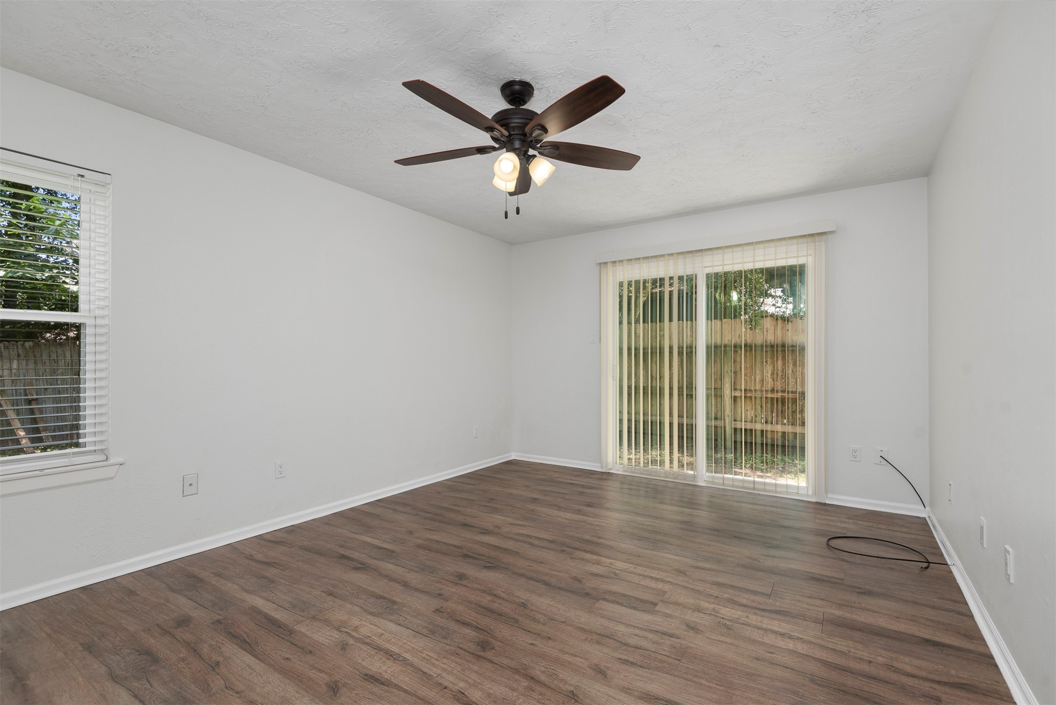 30 Berryfrost Lane The Woodlands, TX 77380 - Photo 17 of 33 a view of an empty room with wooden floor and a window