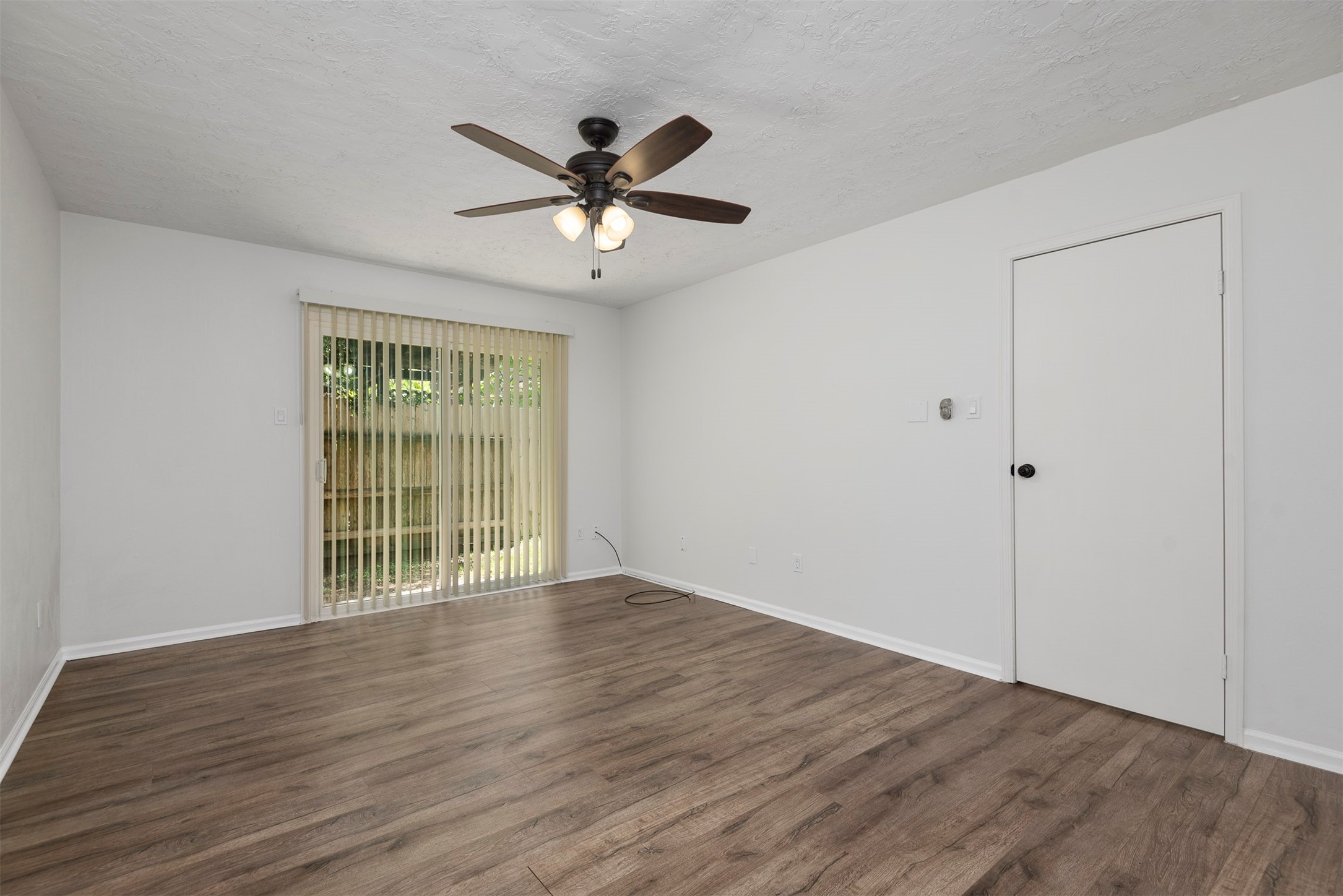 30 Berryfrost Lane The Woodlands, TX 77380 - Photo 18 of 33 a view of an empty room with wooden floor and a window