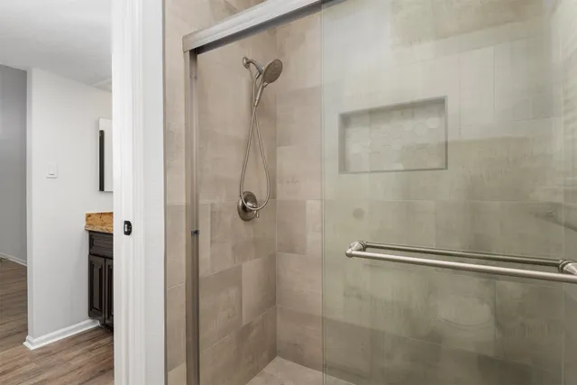 a bathroom with a glass shower door