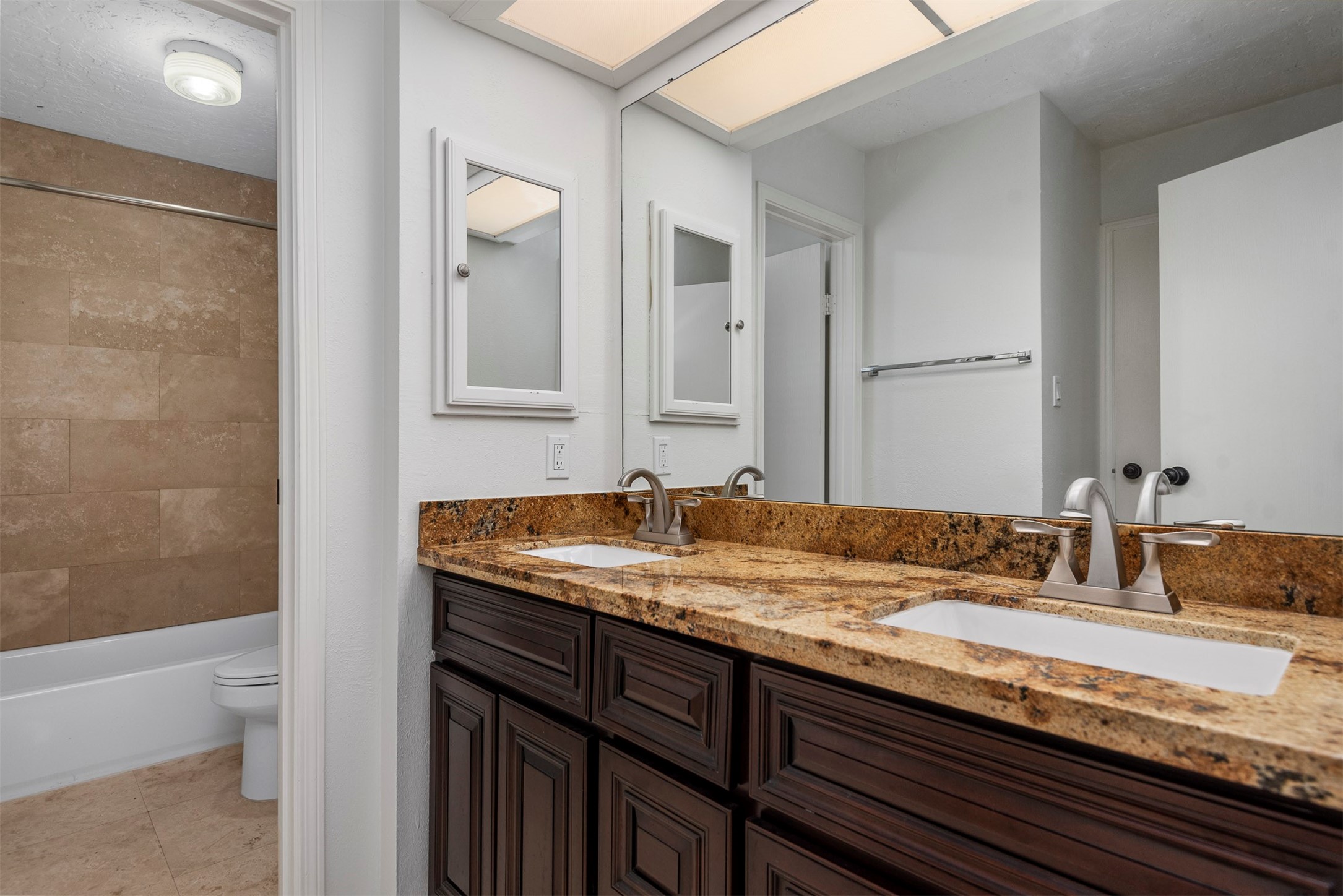 30 Berryfrost Lane The Woodlands, TX 77380 - Photo 28 of 33 a bathroom with a granite countertop sink and a mirror