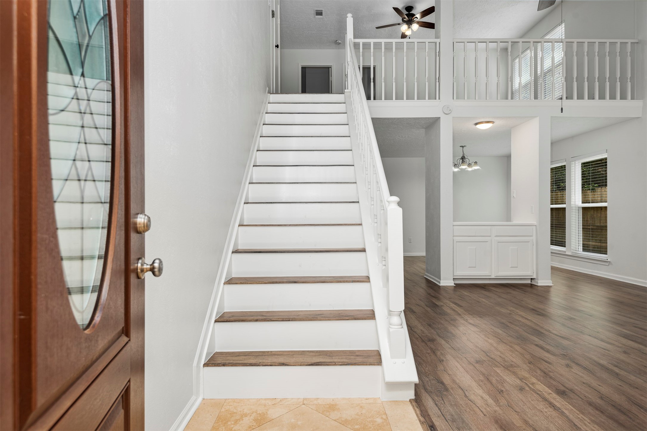 30 Berryfrost Lane The Woodlands, TX 77380 - Photo 3 of 33 a view of an entryway with wooden floor and staircase