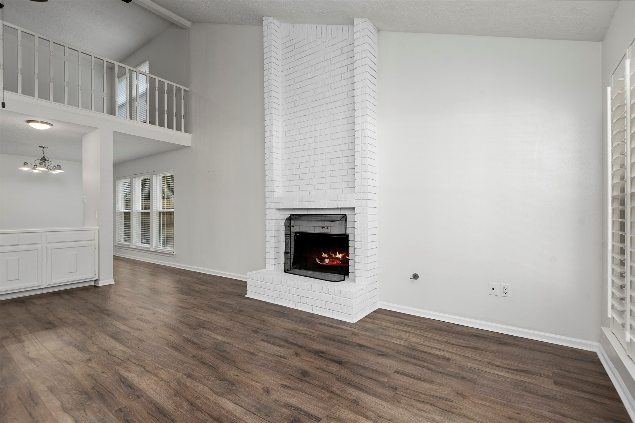 30 Berryfrost Lane The Woodlands, TX 77380 - Photo 4 of 33 a view of an empty room with wooden floor and a fireplace