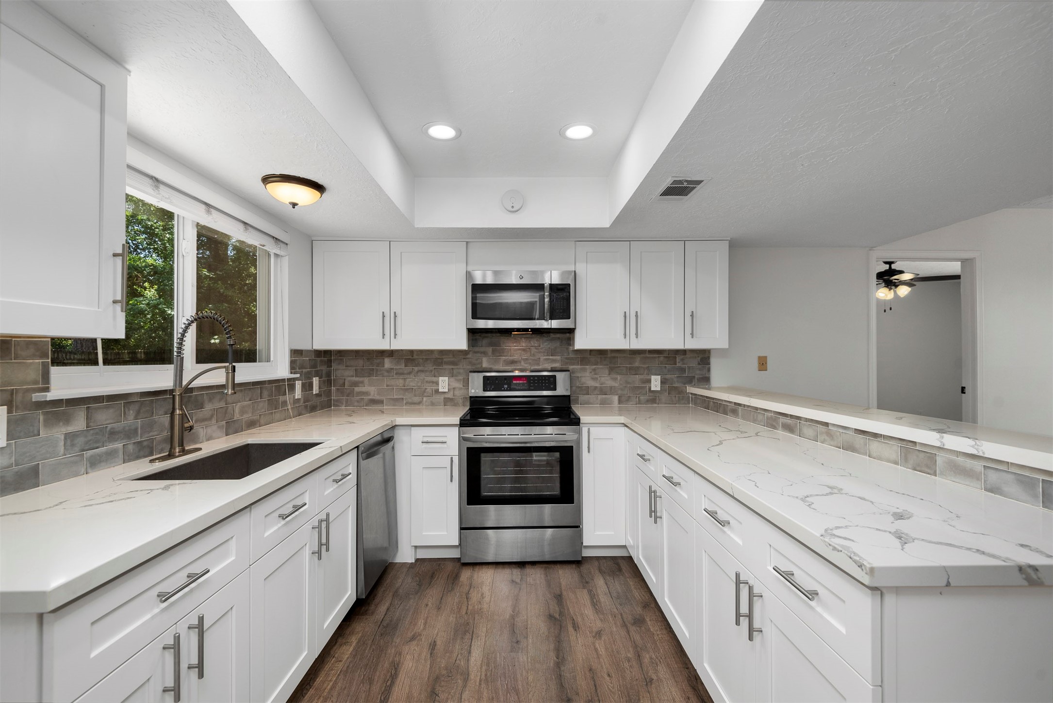 30 Berryfrost Lane The Woodlands, TX 77380 - Photo 9 of 33 a kitchen with a sink stove and cabinets
