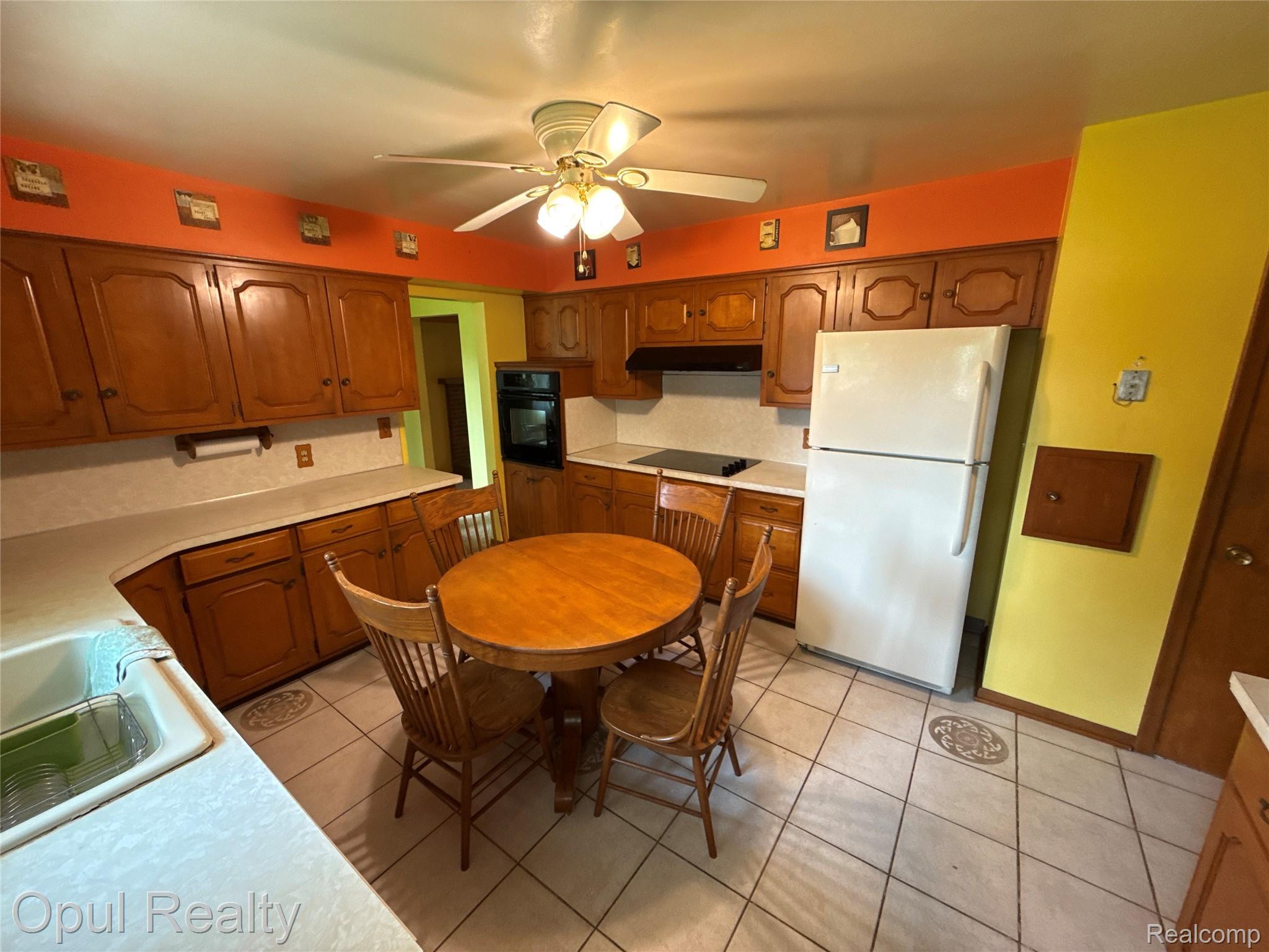 7899 Ida East Road Ida, MI 48140 - Photo 22 of 48 The kitchen features extensive wood cabinetry, white countertops, and white tile flooring