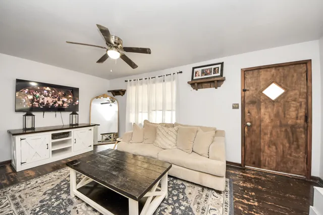 a living room with furniture a rug and a window
