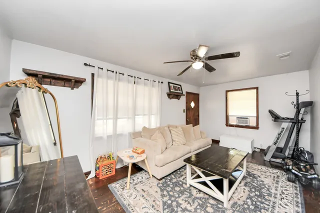a living room with furniture a rug and a window