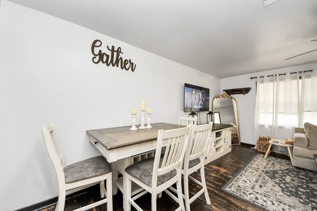 a kitchen with granite countertop a stove and white cabinets