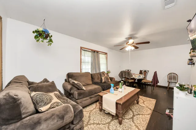 a dining room with furniture and wooden floor