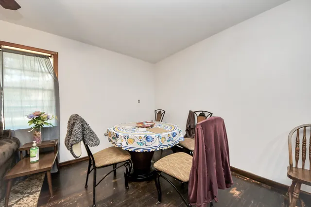 a living room with furniture and a dining table