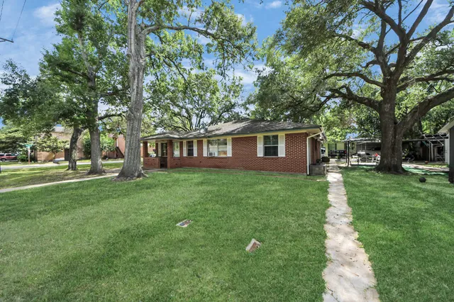 a view of a house with backyard porch and sitting area