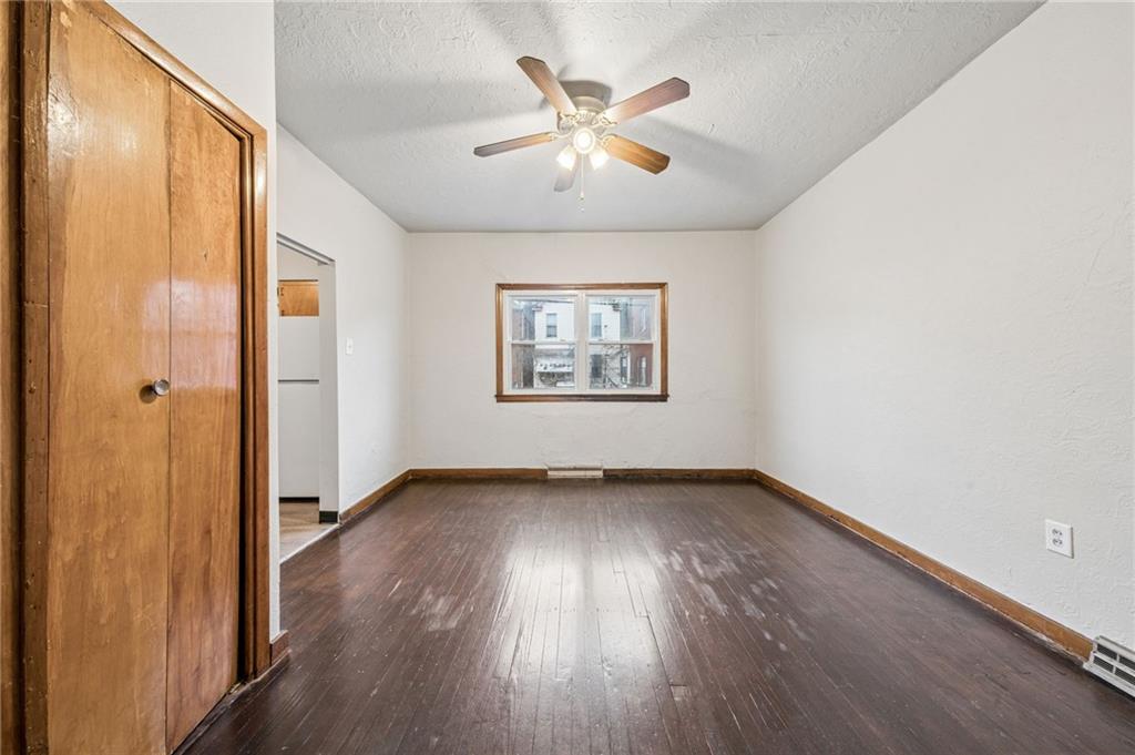 620 Broadway Avenue McKees Rocks, PA 15136 - Photo 6 of 18 an empty room with wooden floor and windows