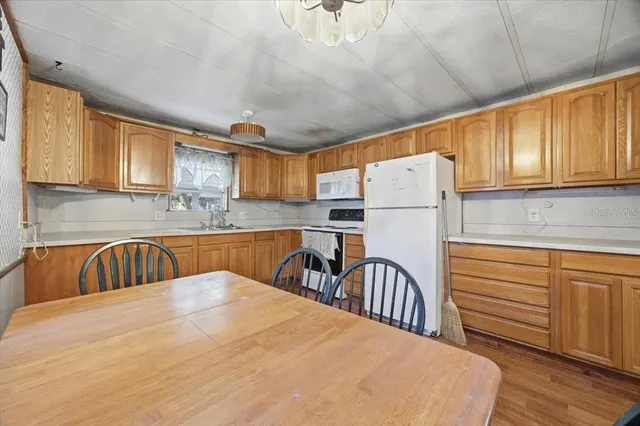 a kitchen with granite countertop a sink stainless steel appliances and cabinets