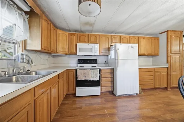 a kitchen with refrigerator and cabinets
