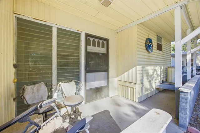a balcony with furniture and a potted plant