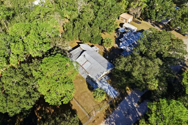 an aerial view of a house with a yard