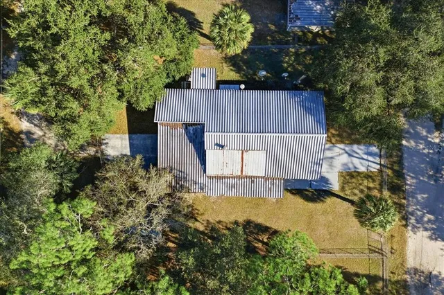 a view of a backyard with a small cabin and a chair