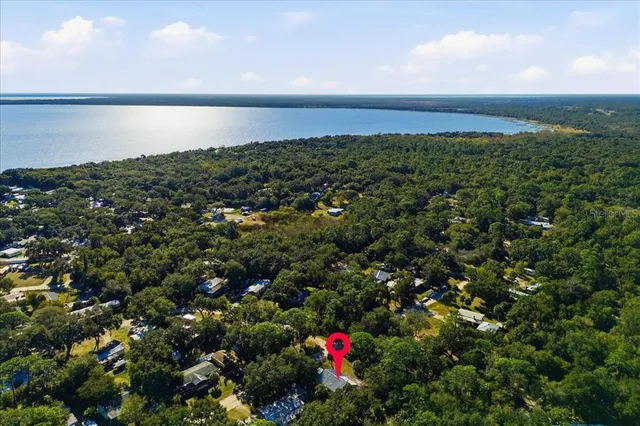 a view of a swimming pool with a patio and a yard