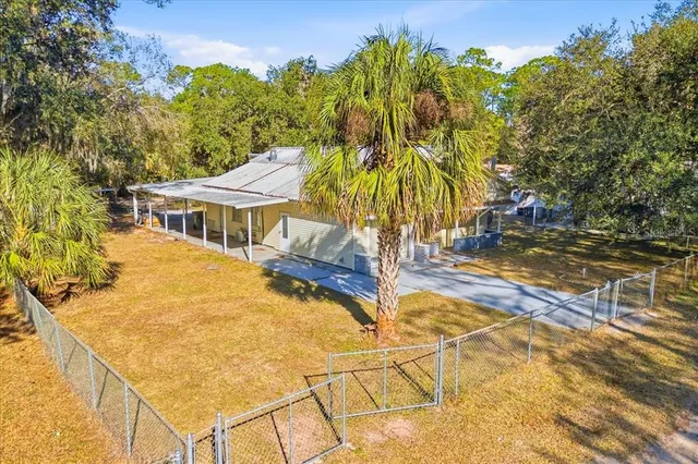 a view of a house with a yard balcony and tree s