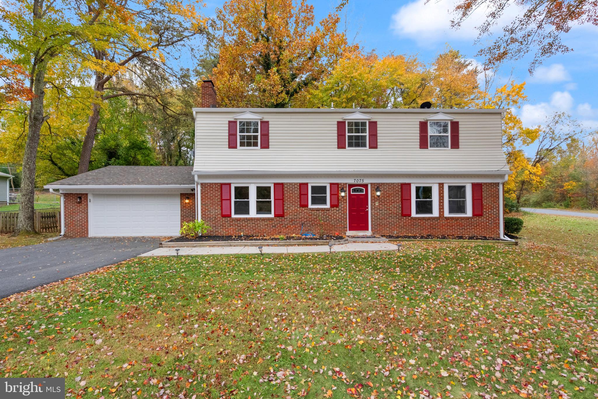 Charming home surrounded by autumn hues.