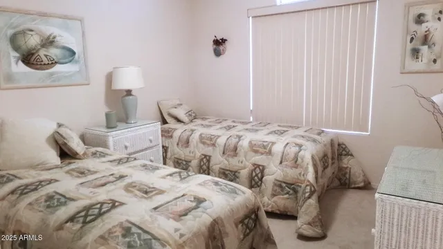 a bedroom with a bed and painting on the wall