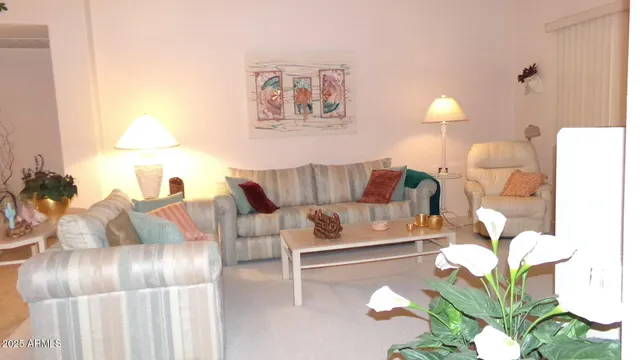 a living room with furniture and a lamp