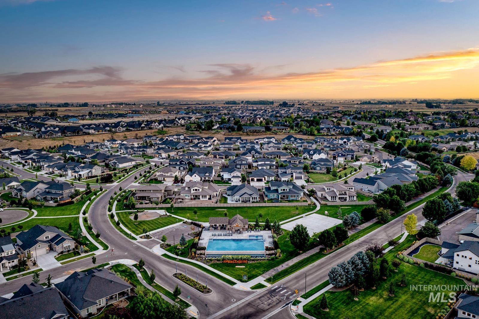 5817 South Gustav Avenue Meridian, ID 83642 - Photo 30 of 33 Aerial perspective showcasing a residential community with an outdoor swimming pool, surrounding green spaces, and a network of paved streets