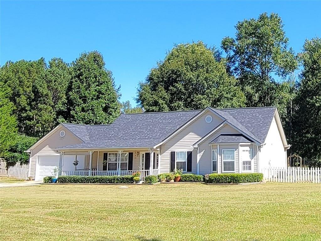 3661 Davis Academy Road Rutledge, GA 30663 - Photo 1 of 1 a house that has a big yard plants and trees in the background