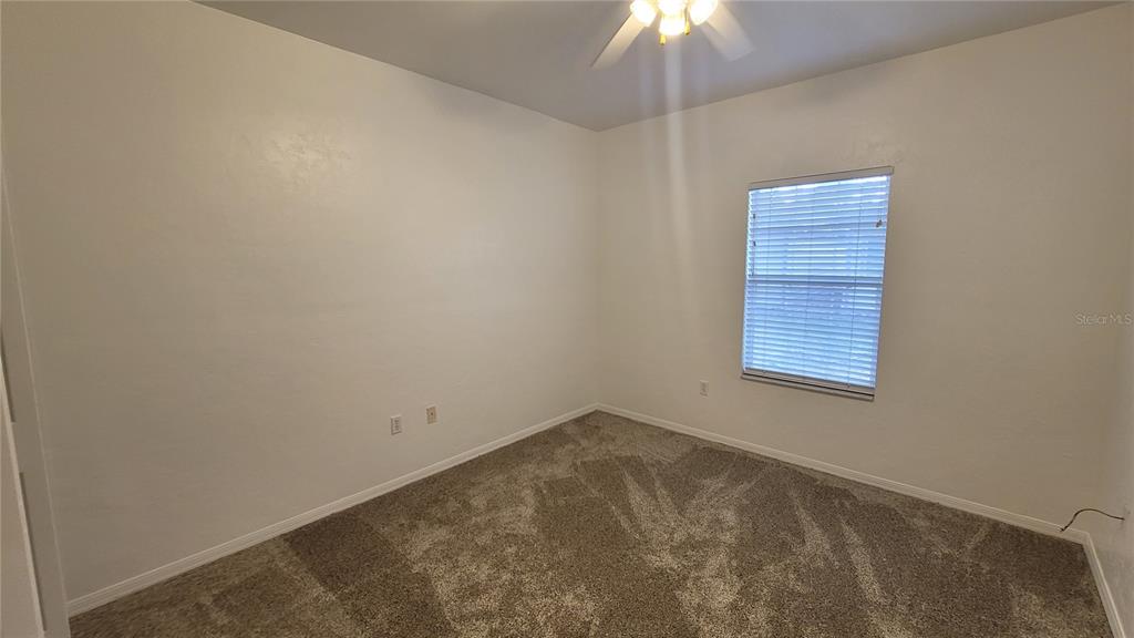 4926 Northwest 78 Road Gainesville, FL 32653 - Photo 15 of 18 an empty room with a chandelier fan