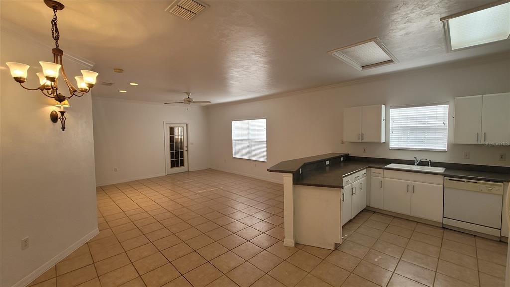 4926 Northwest 78 Road Gainesville, FL 32653 - Photo 3 of 18 a kitchen with granite countertop white cabinets and white appliances