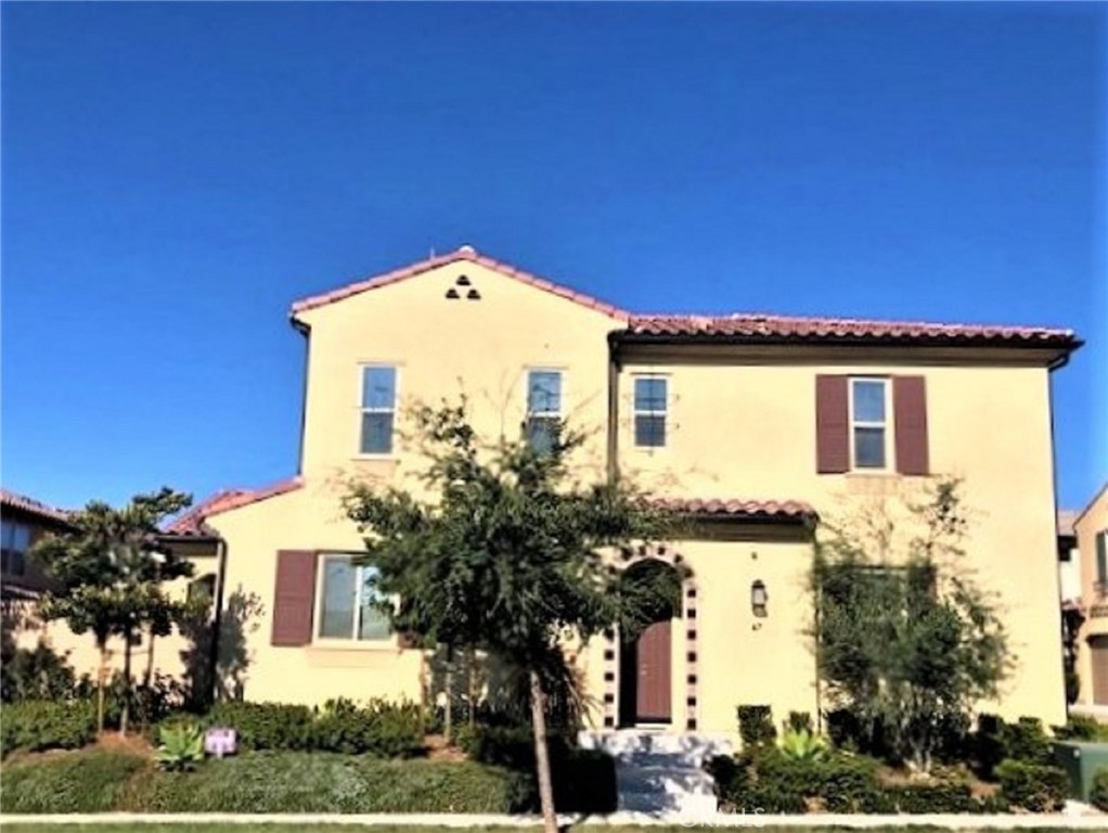 67 Eclipse Lake Forest, CA 92630 - Photo 2 of 20 a front view of a house with a garden
