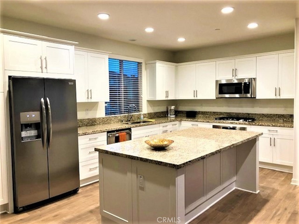 67 Eclipse Lake Forest, CA 92630 - Photo 6 of 20 a kitchen with stainless steel appliances granite countertop a sink stove and refrigerator