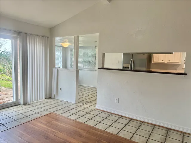 a view of a livingroom with wooden floor and cabinet