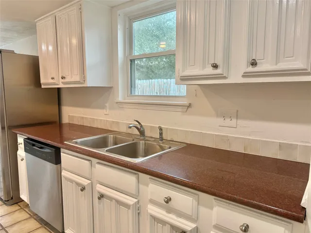 a kitchen with a sink cabinets and window