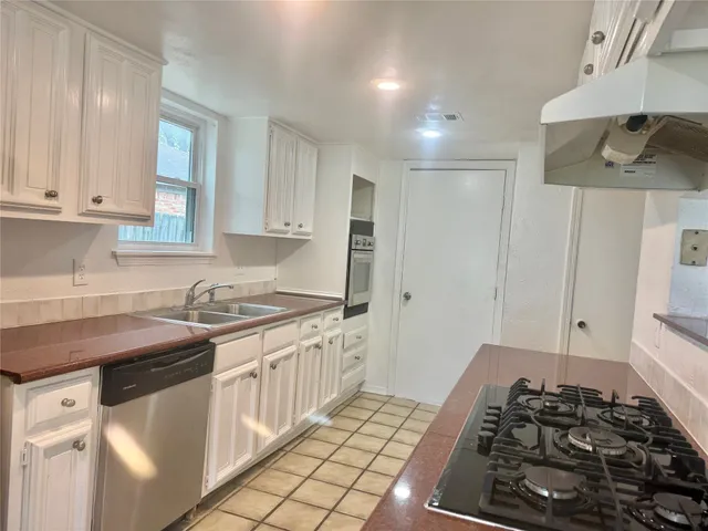 a kitchen with stainless steel appliances granite countertop a stove and a sink
