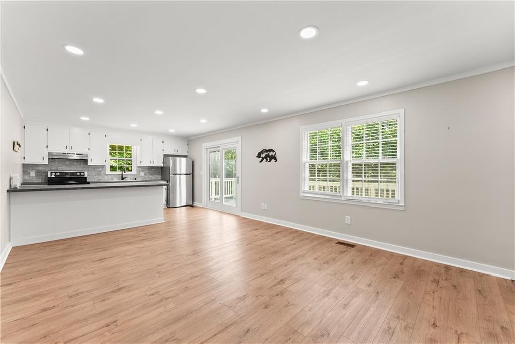 31 Pine Road Dahlonega, GA 30533 - Photo 9 of 32 a view of an empty room with kitchen counter space and wooden floor