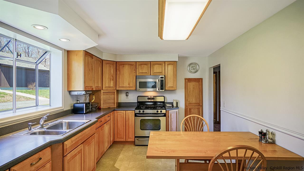 124 Wilhelm Road Saugerties, NY 12477 - Photo 17 of 33 a kitchen with a stove a sink and a refrigerator