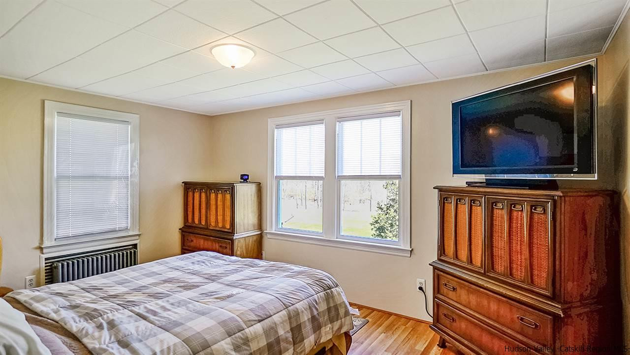 124 Wilhelm Road Saugerties, NY 12477 - Photo 20 of 33 a bedroom with a bed next to a window