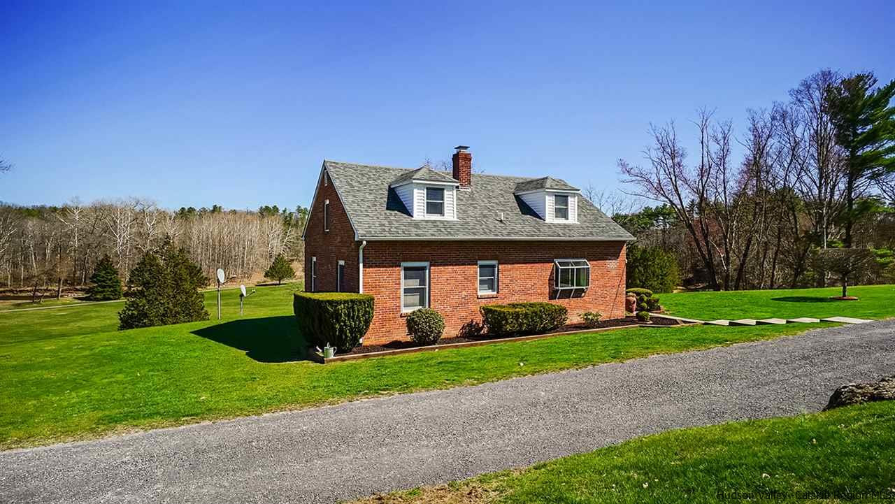 124 Wilhelm Road Saugerties, NY 12477 - Photo 2 of 33 a front view of a house with a yard and garage