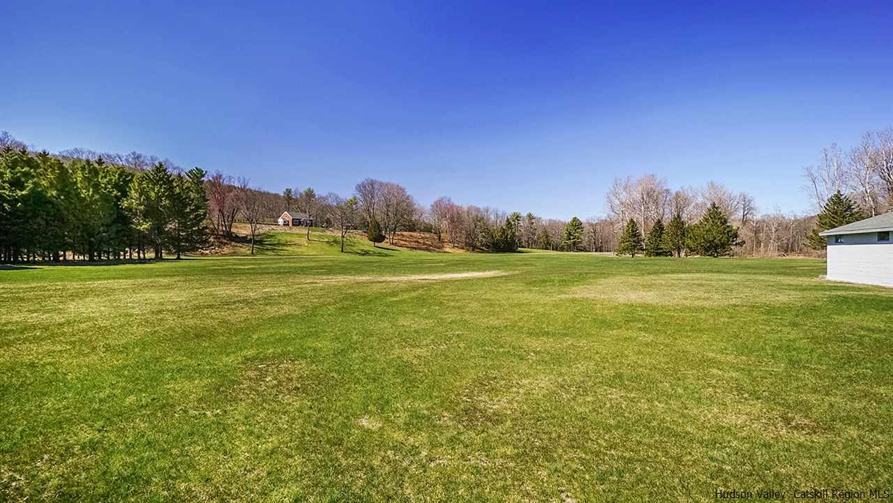 124 Wilhelm Road Saugerties, NY 12477 - Photo 5 of 33 a view of a field with an trees in the background