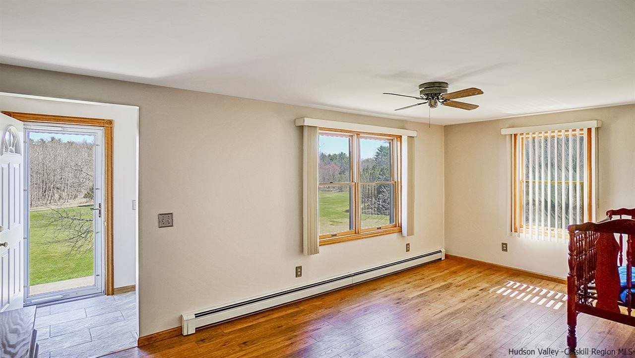 124 Wilhelm Road Saugerties, NY 12477 - Photo 7 of 33 a view of an empty room with a window and wooden floor