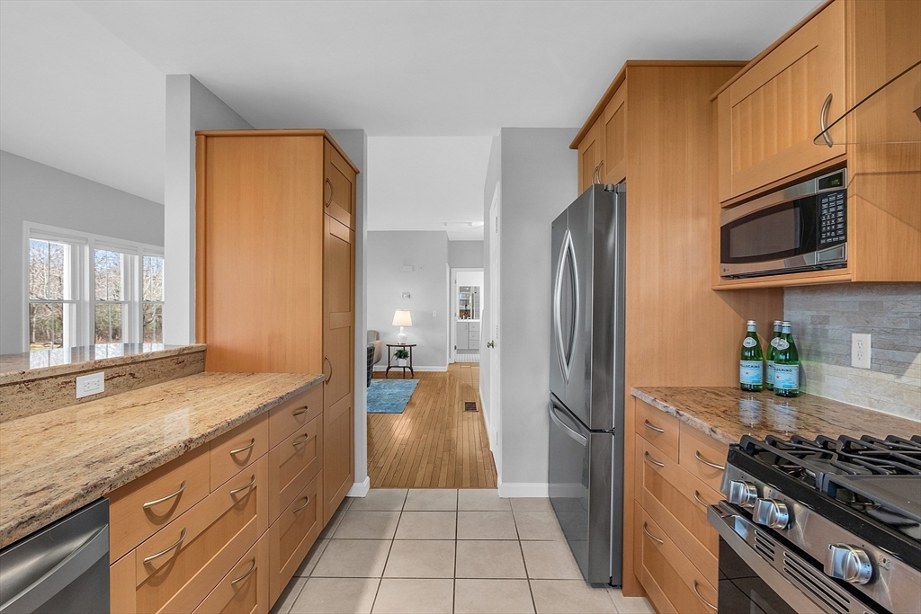 19 S Commons, Unit D Lincoln, MA 01773 - Photo 11 of 41 a kitchen with stainless steel appliances granite countertop a refrigerator and a stove