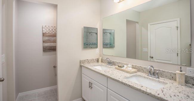 3 Porter Lane Palm Coast, FL 32164 - Photo 11 of 15 a bathroom with a granite countertop sink and a mirror