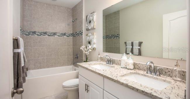 3 Porter Lane Palm Coast, FL 32164 - Photo 12 of 15 a bathroom with a granite countertop sink toilet and shower