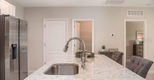 3 Porter Lane Palm Coast, FL 32164 - Photo 7 of 15 a kitchen with a refrigerator and a sink