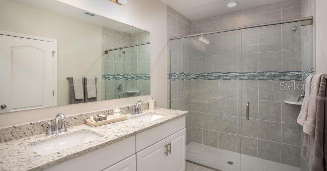 3 Porter Lane Palm Coast, FL 32164 - Photo 10 of 15 a bathroom with a granite countertop shower sink and mirror