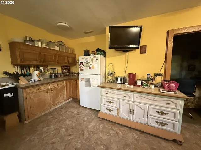 a kitchen with stainless steel appliances kitchen island granite countertop a sink and cabinets