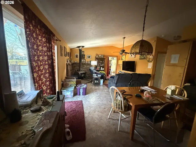 a living room with furniture a rug and a flat screen tv