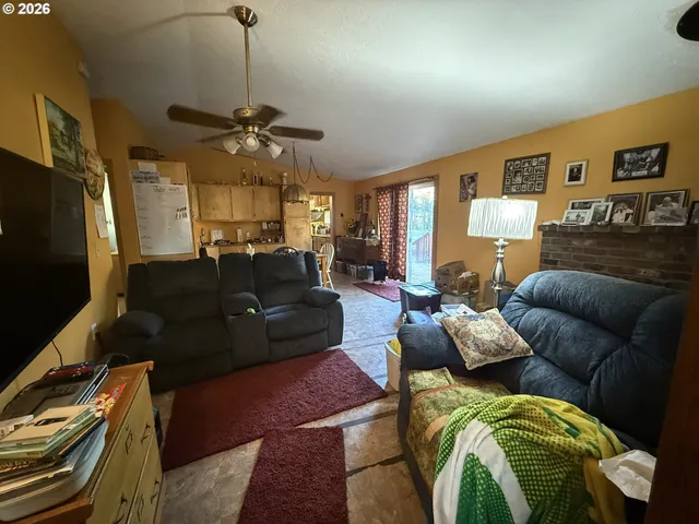 a living room with furniture a ceiling fan and a rug