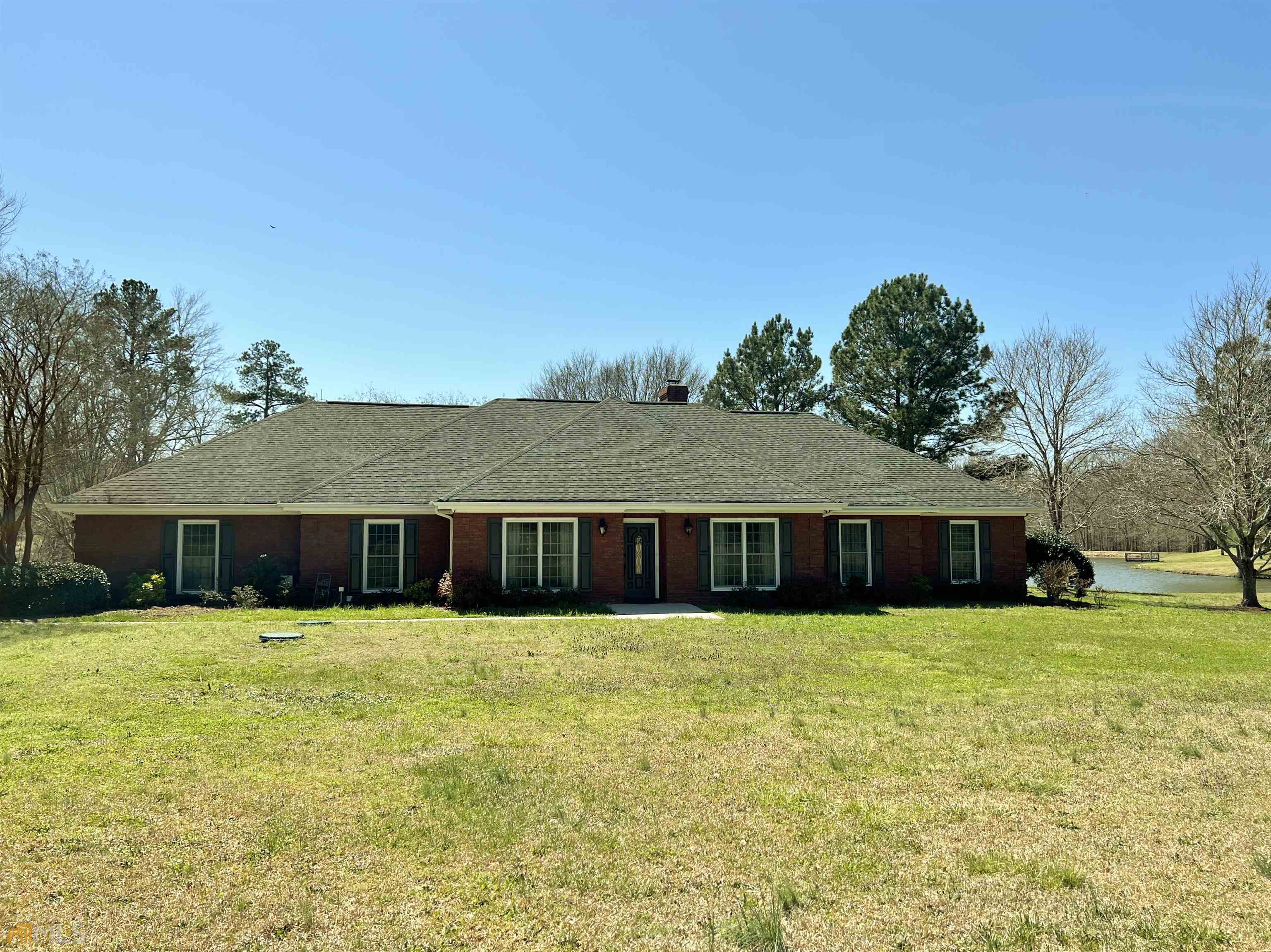 2000 Jersey Social Circle Road Covington, GA 30014 - Photo 1 of 1 a view of a house with a yard and large trees
